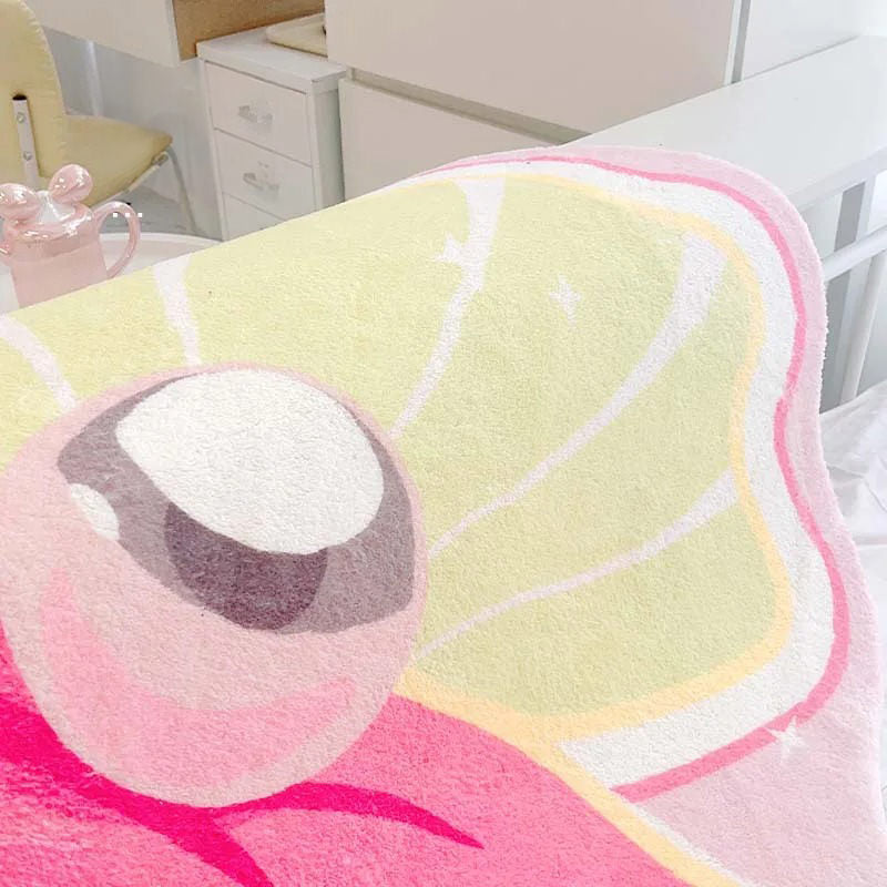 Różowy dywanik dekoracyjny w kształcie muszli