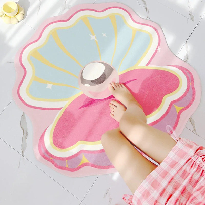 Różowy dywanik dekoracyjny w kształcie muszli