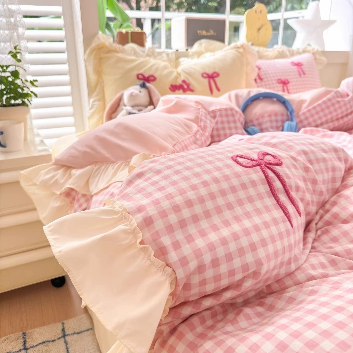 Zestaw pościeli w pastelowym różu i kraciasty wzór z kokardami